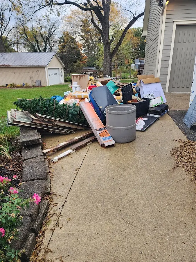 Dumpster being loaded with debris for 12 Yard Dumpster Rental in Moline
